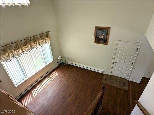 2327 Iron Dr, Ely, NV 89301 - laundry area featuring a baseboard heating unit, wood finished floors, and baseboards