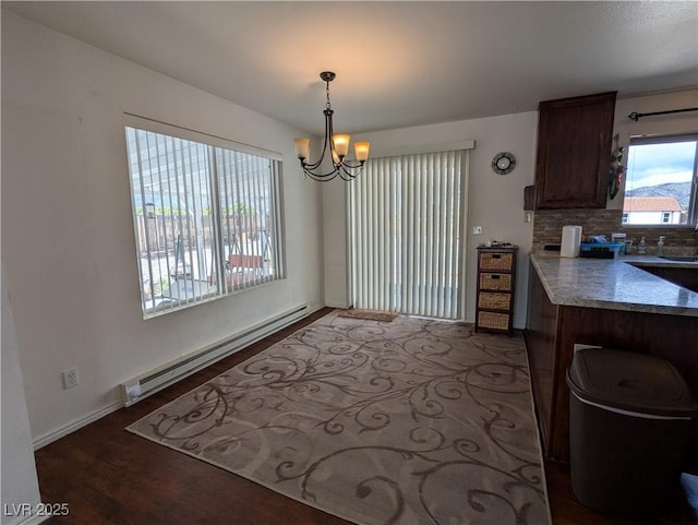 2327 Iron Dr, Ely, NV 89301 - dining area with a baseboard radiator, a chandelier, wood finished floors, and baseboards