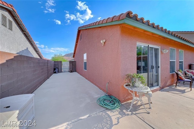 view of side of property with a patio area