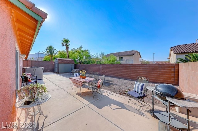 view of patio / terrace featuring grilling area and a storage shed