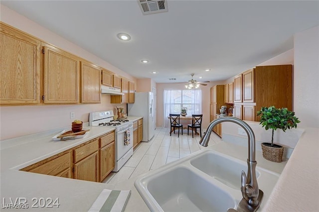 kitchen with ceiling fan, sink, white appliances, and light brown cabinets