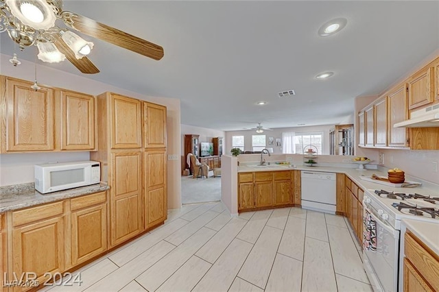 kitchen with ceiling fan, sink, kitchen peninsula, white appliances, and exhaust hood