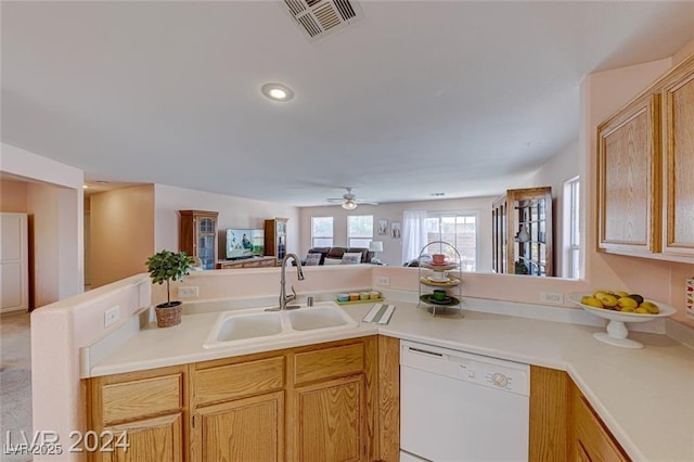 kitchen with white dishwasher, ceiling fan, sink, and light brown cabinetry