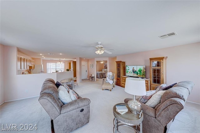 carpeted living room featuring ceiling fan