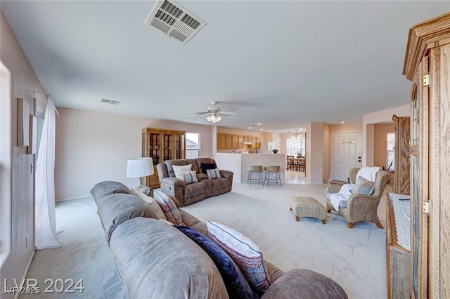 living room featuring ceiling fan and light carpet