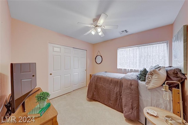 carpeted bedroom with a closet and ceiling fan