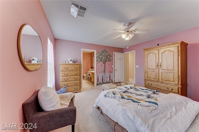 bedroom with light carpet, connected bathroom, and ceiling fan