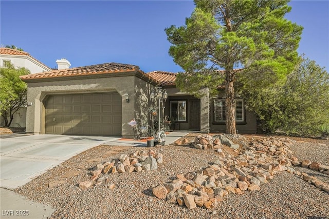 mediterranean / spanish house with a garage