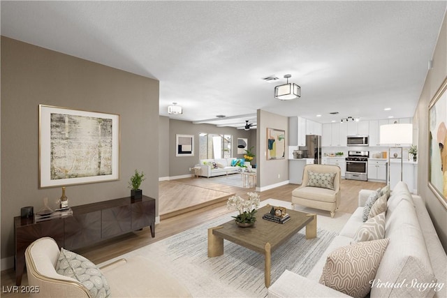 living room featuring ceiling fan and light wood-type flooring