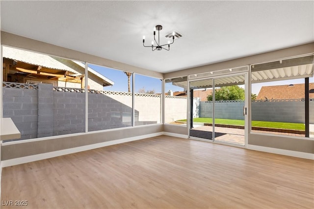 unfurnished sunroom featuring an inviting chandelier