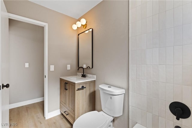 bathroom with hardwood / wood-style floors, vanity, and toilet