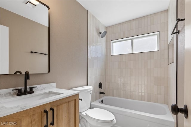 full bathroom featuring toilet, vanity, and tiled shower / bath combo