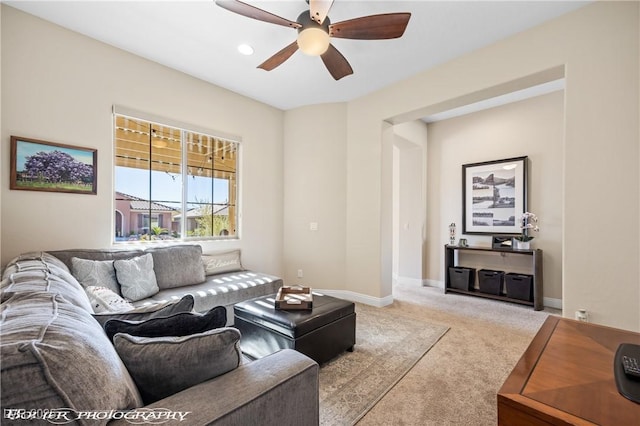 living room with ceiling fan and light carpet