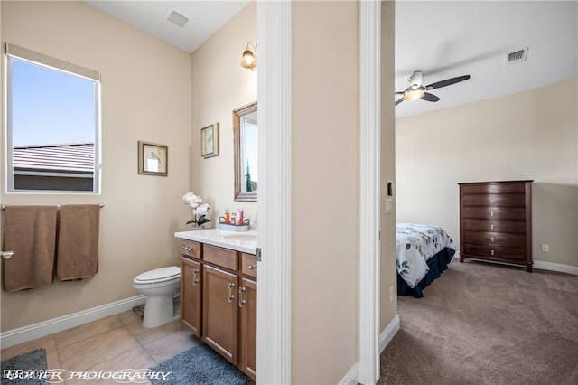 bathroom with ceiling fan, tile patterned flooring, vanity, and toilet