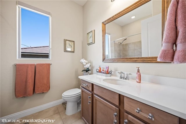 bathroom with tile patterned flooring, a tile shower, vanity, and toilet