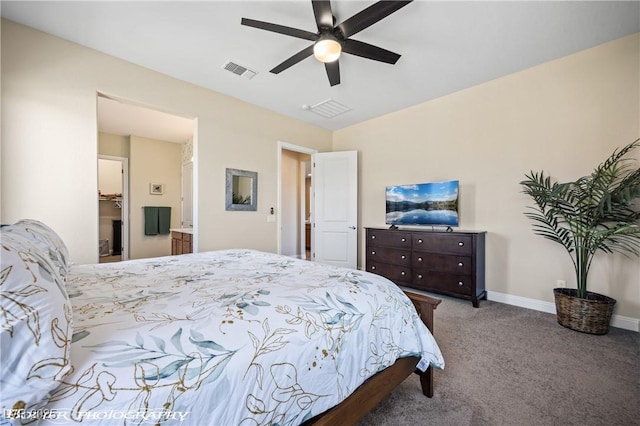 carpeted bedroom with a walk in closet and ceiling fan