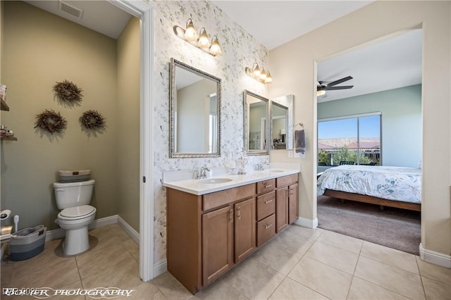 bathroom with tile patterned floors, ceiling fan, vanity, and toilet