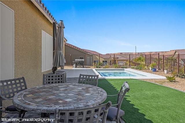 view of swimming pool featuring a lawn and a patio area