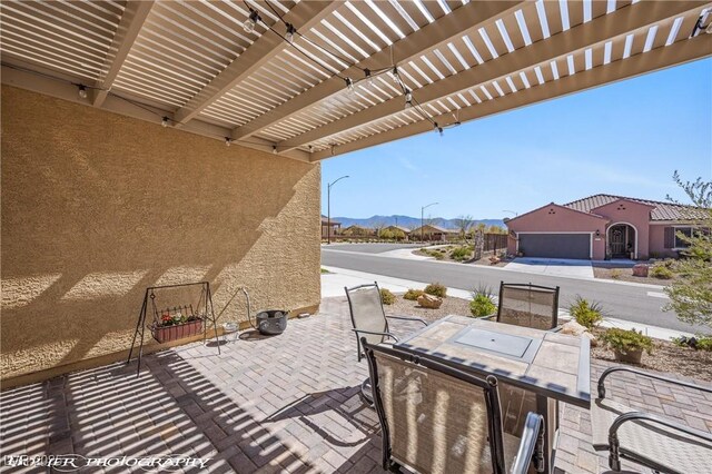 view of patio / terrace with a pergola and a mountain view