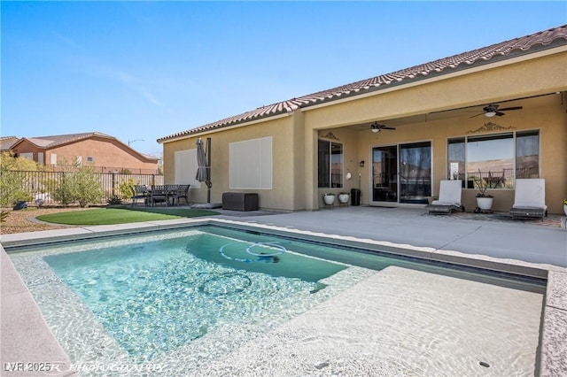 view of pool with ceiling fan and a patio