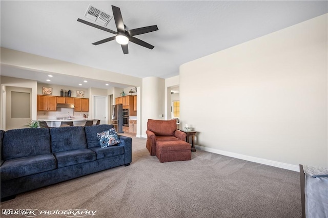 carpeted living room featuring ceiling fan