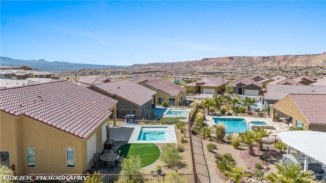 view of pool featuring a patio area, a mountain view, and central AC unit