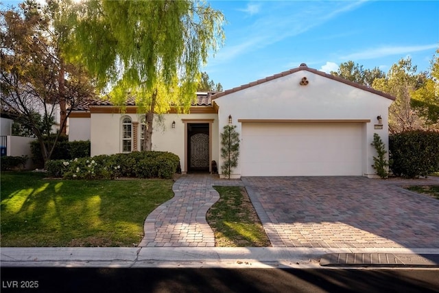 mediterranean / spanish-style home featuring a front yard and a garage