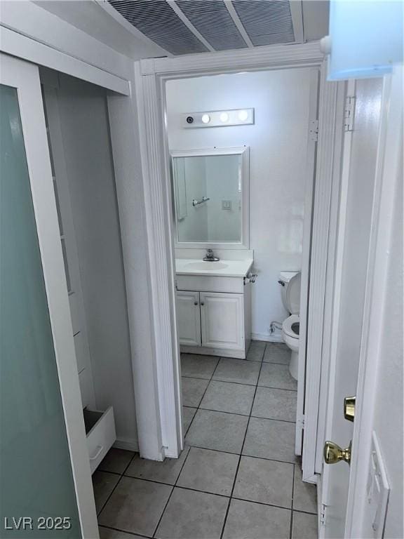 bathroom featuring tile patterned floors, vanity, and toilet