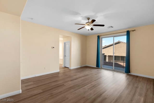 spare room featuring hardwood / wood-style floors and ceiling fan