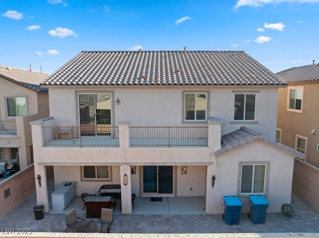 back of house featuring a patio area and a balcony