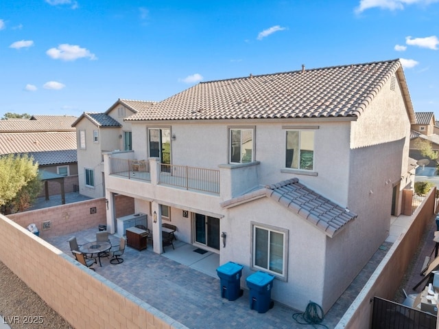 back of property featuring a patio area and a balcony