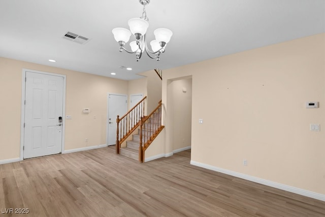 interior space featuring a notable chandelier and light wood-type flooring