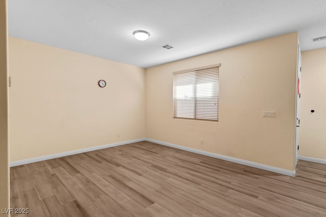 spare room with light hardwood / wood-style flooring