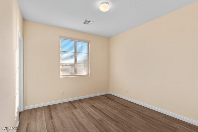 unfurnished room with light wood-type flooring