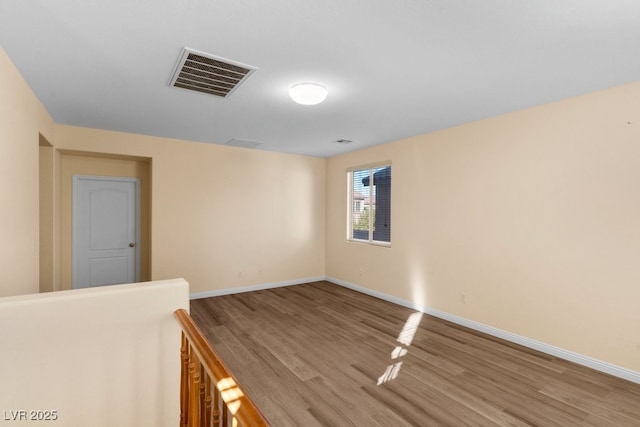 empty room with hardwood / wood-style floors