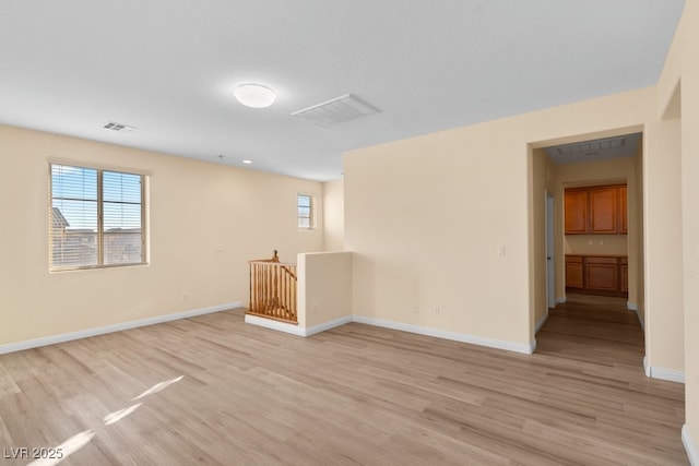 empty room with light hardwood / wood-style flooring