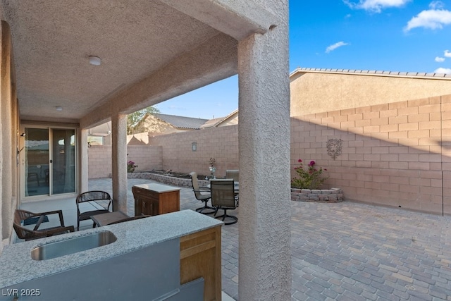 view of patio / terrace featuring an outdoor wet bar