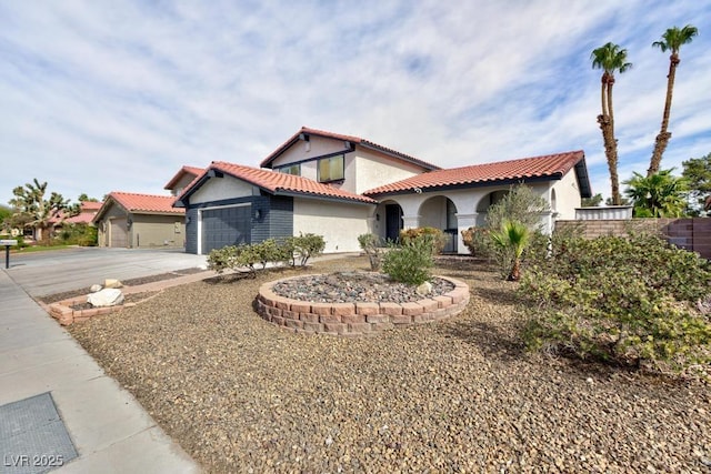 mediterranean / spanish-style home with a garage