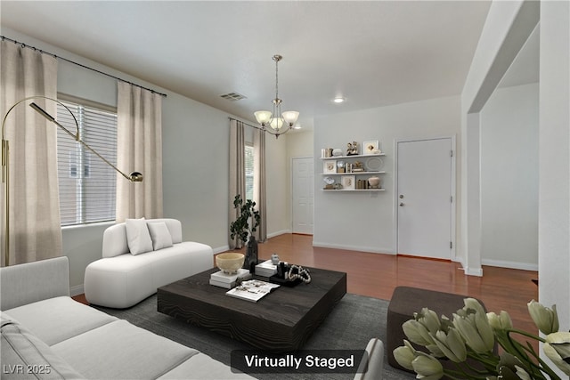 living room featuring hardwood / wood-style flooring and a notable chandelier