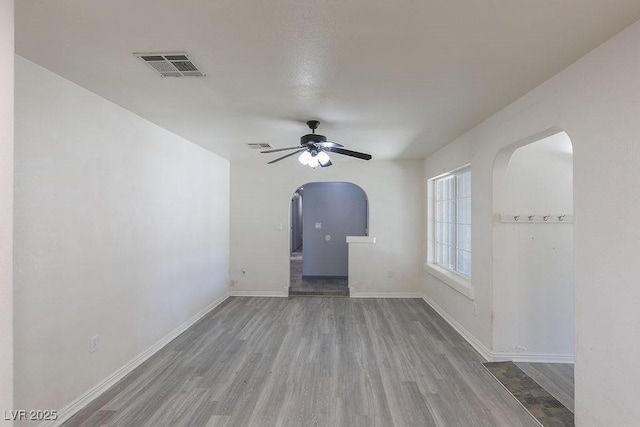 spare room featuring hardwood / wood-style flooring and ceiling fan