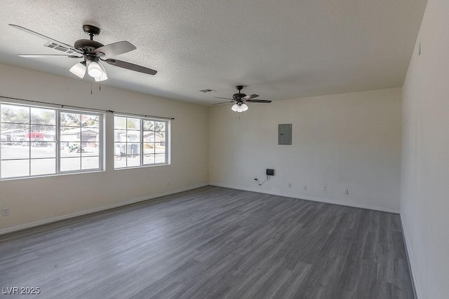 empty room featuring a textured ceiling, ceiling fan, dark wood-type flooring, and electric panel