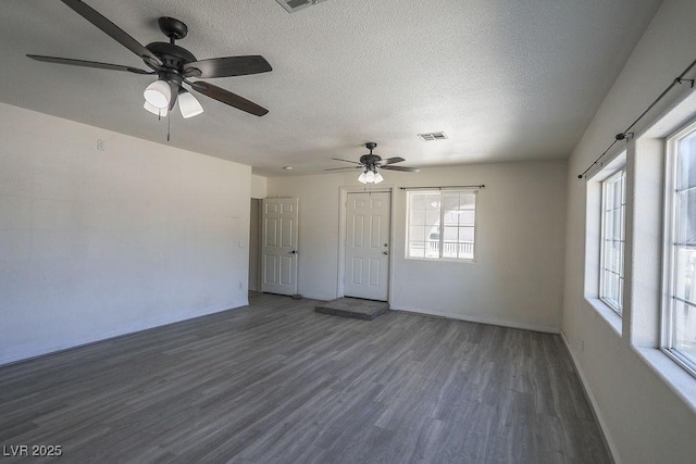 interior space featuring a textured ceiling, ceiling fan, and dark hardwood / wood-style floors