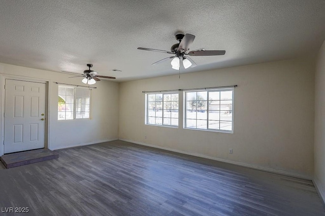 interior space featuring dark hardwood / wood-style floors, ceiling fan, and a textured ceiling