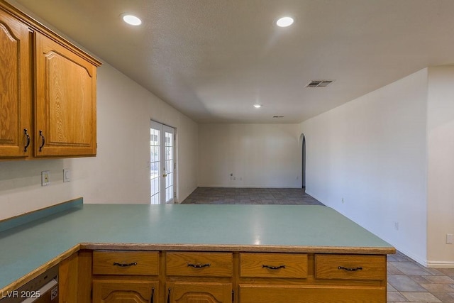 kitchen featuring dishwashing machine, kitchen peninsula, and french doors