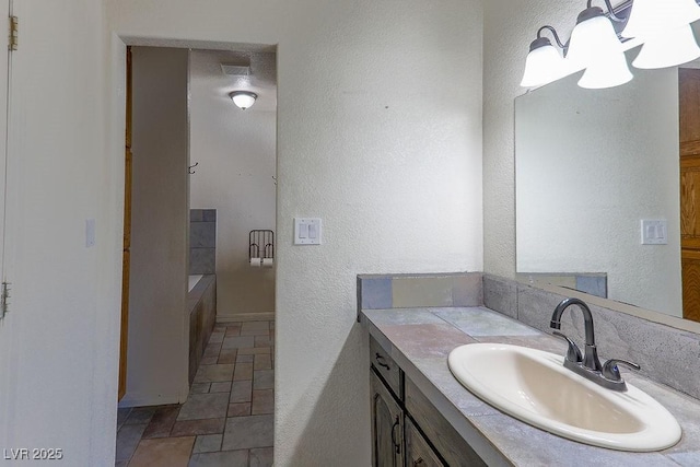 bathroom featuring vanity and a tub to relax in