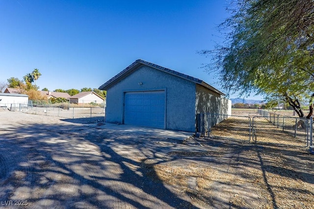 view of side of home featuring a garage and an outdoor structure