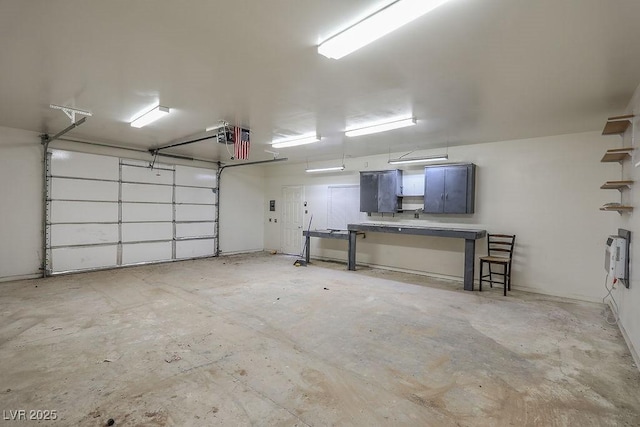 garage featuring heating unit and a garage door opener