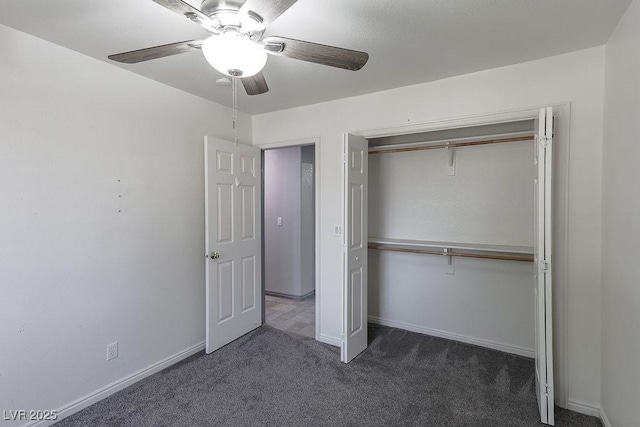 unfurnished bedroom featuring ceiling fan, a closet, and dark colored carpet