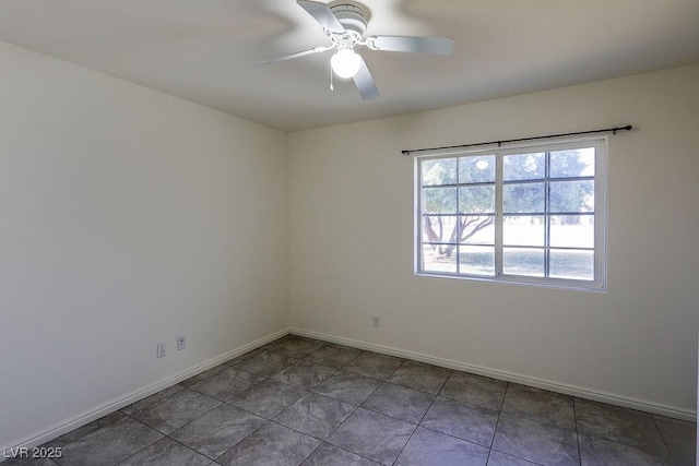 tiled empty room featuring ceiling fan