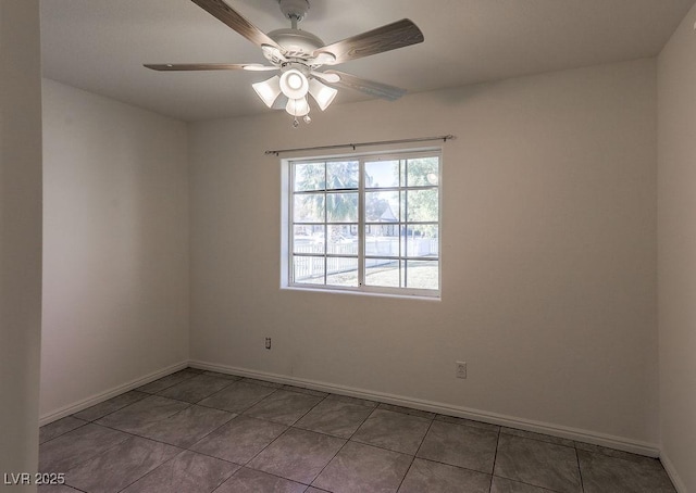 tiled spare room featuring ceiling fan